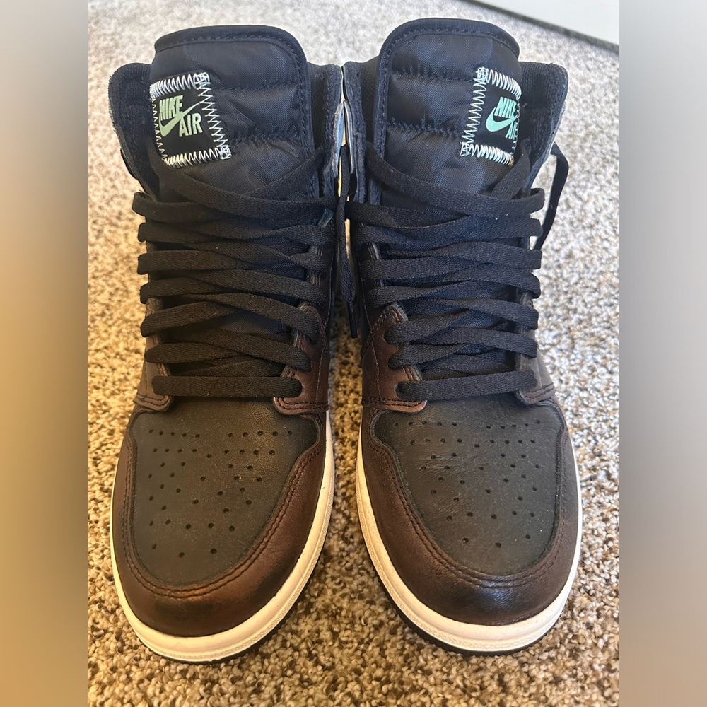Jordan 1 mid, size 10, and never been worn.  Black, brown, and grey